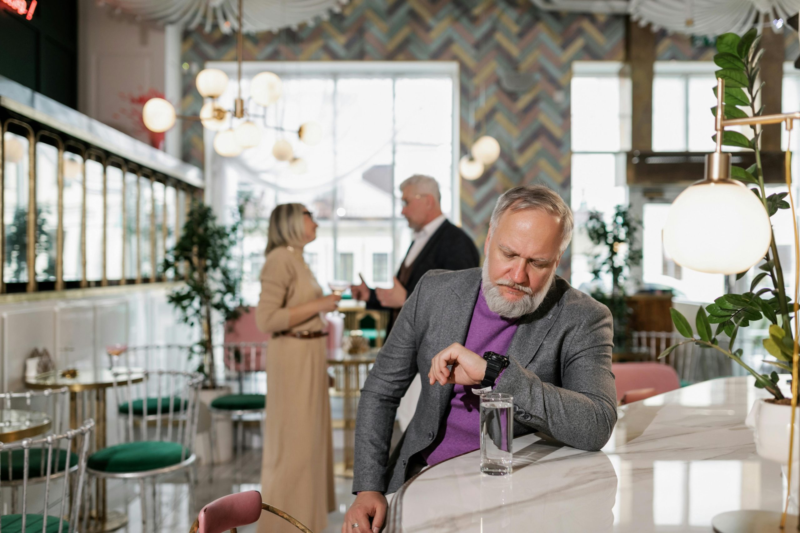 Man in GrayHow to Manage Your Restaurant During Peak Hours Suit Jacket Looking at his Watch